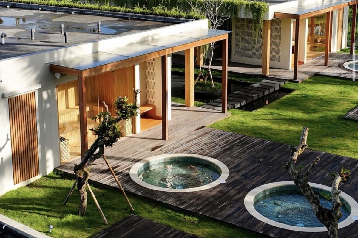 Residential development with a sauna cabin and round plunge pools on a shared lawn